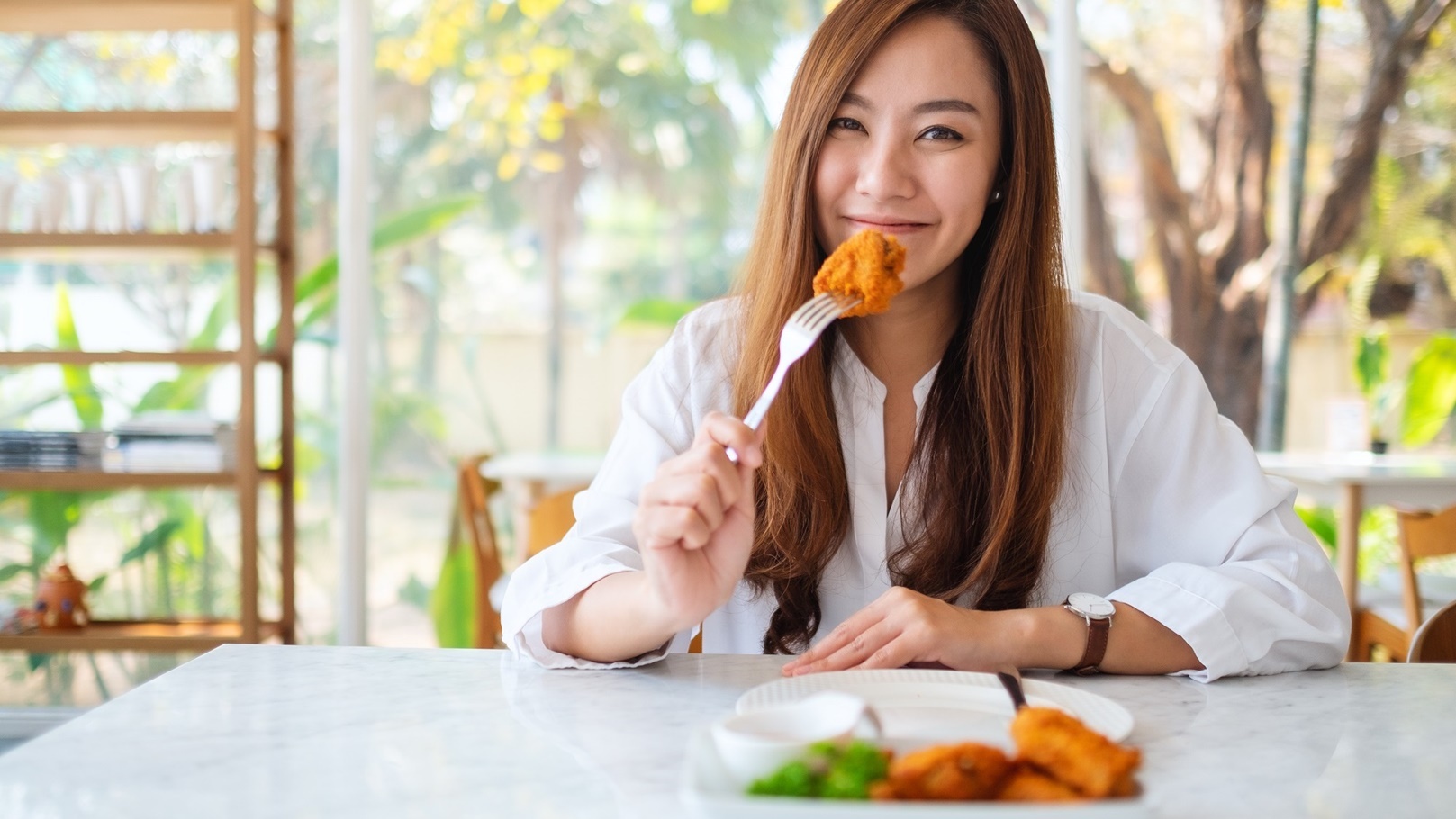 closeup-image-of-a-beautiful-asian-woman-eating-fr-2022-01-28-03-52-55-utc