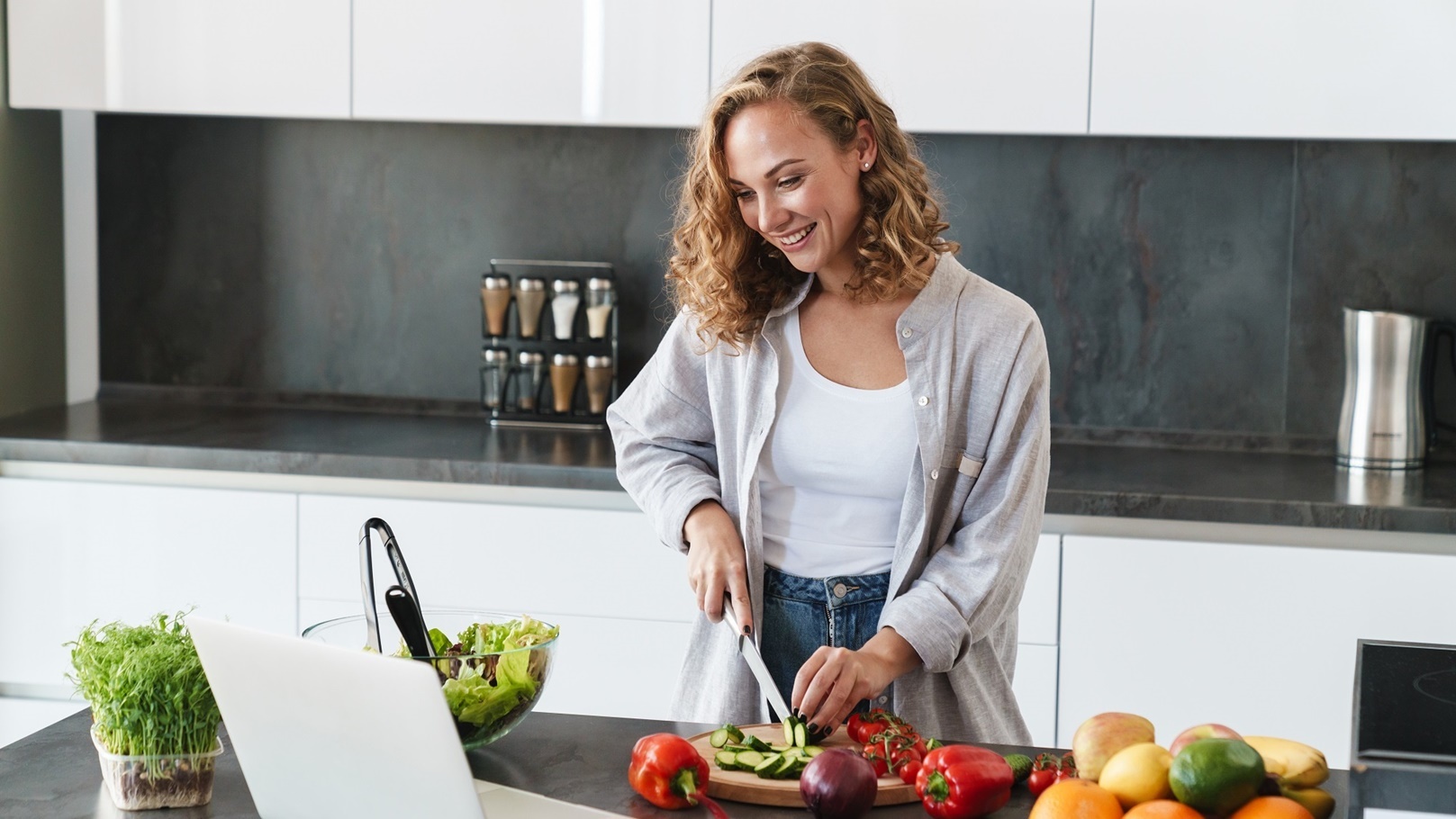 happy-young-woman-making-a-salad-at-the-kitchen-2022-02-02-04-51-14-utc (1)