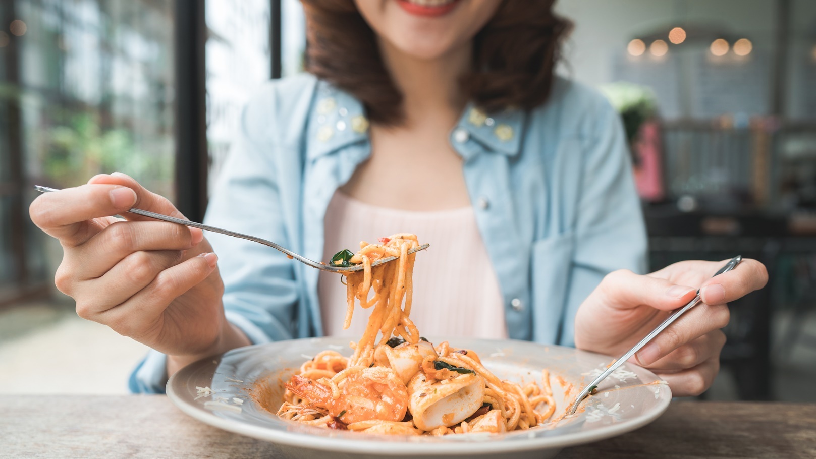 beautiful-happy-asian-woman-eating-a-plate-of-ital-2022-02-05-03-37-09-utc