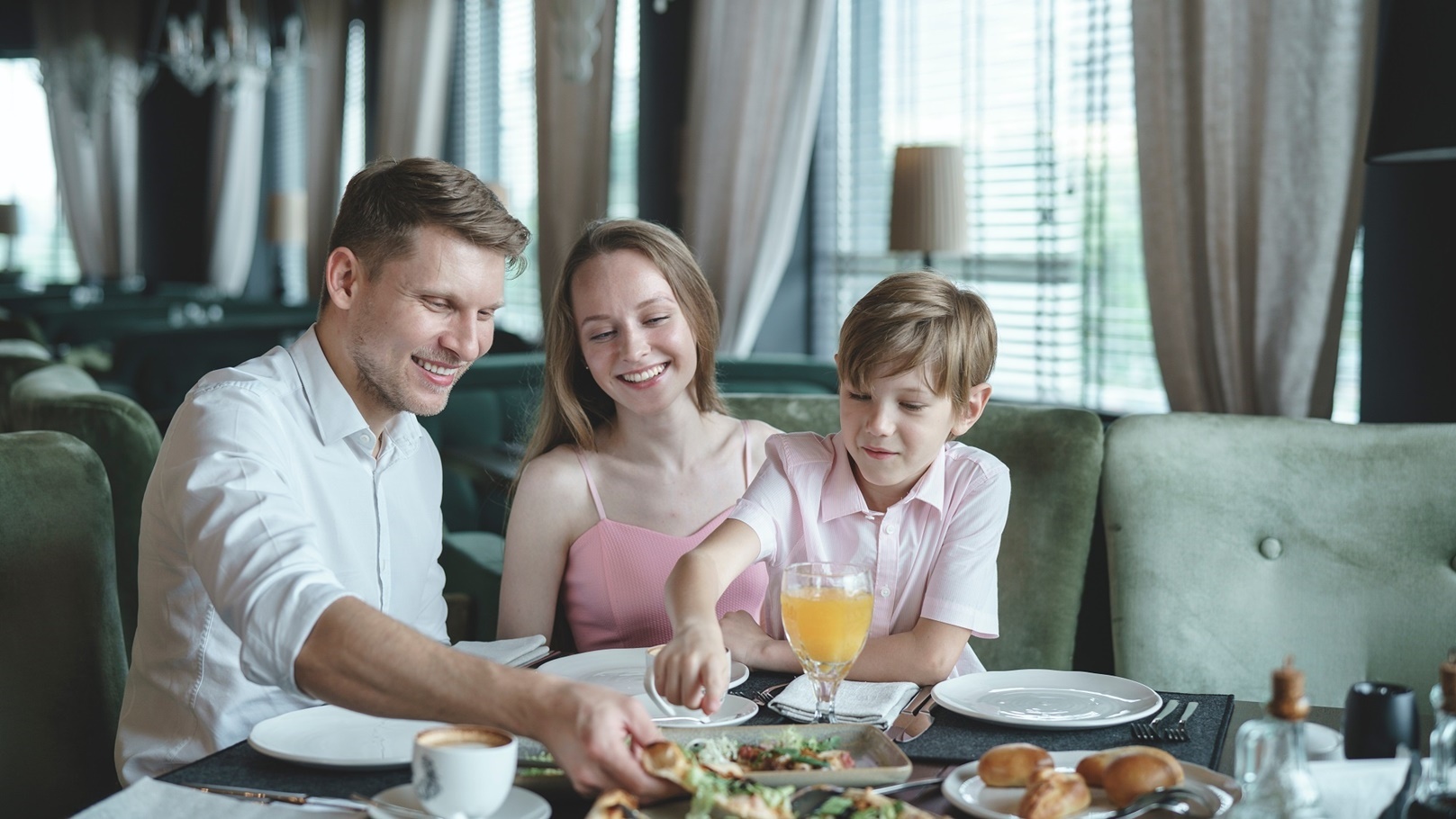 happy-family-in-a-restaurant-2021-08-26-15-47-32-utc