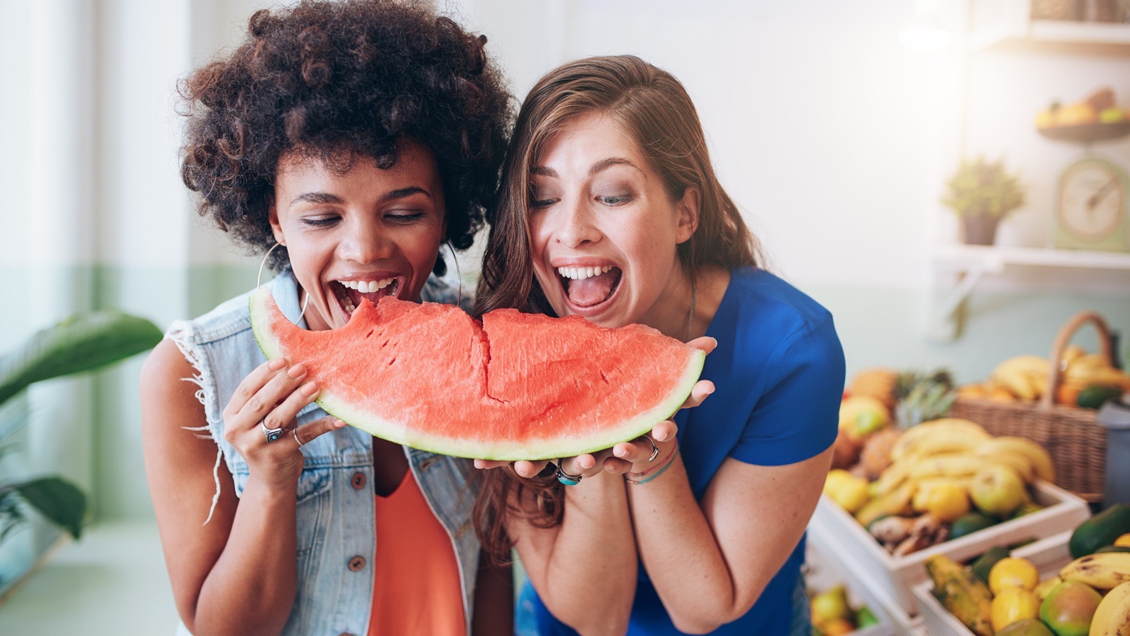 two-women-taking-a-bite-of-a-watermelon-2021-08-26-19-58-15-utc