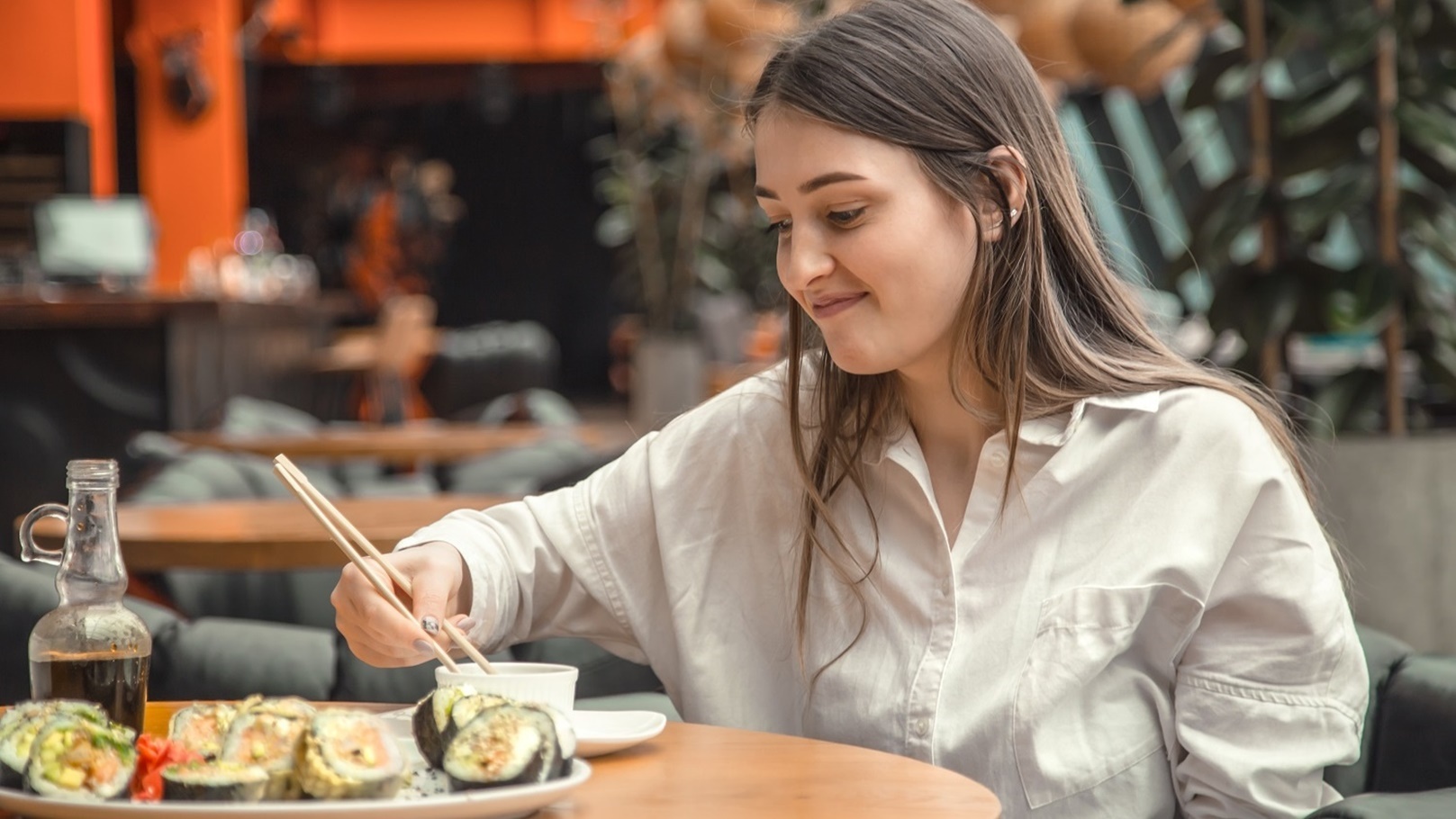 young-woman-eating-and-enjoying-fresh-sushi-2021-09-02-06-26-05-utc