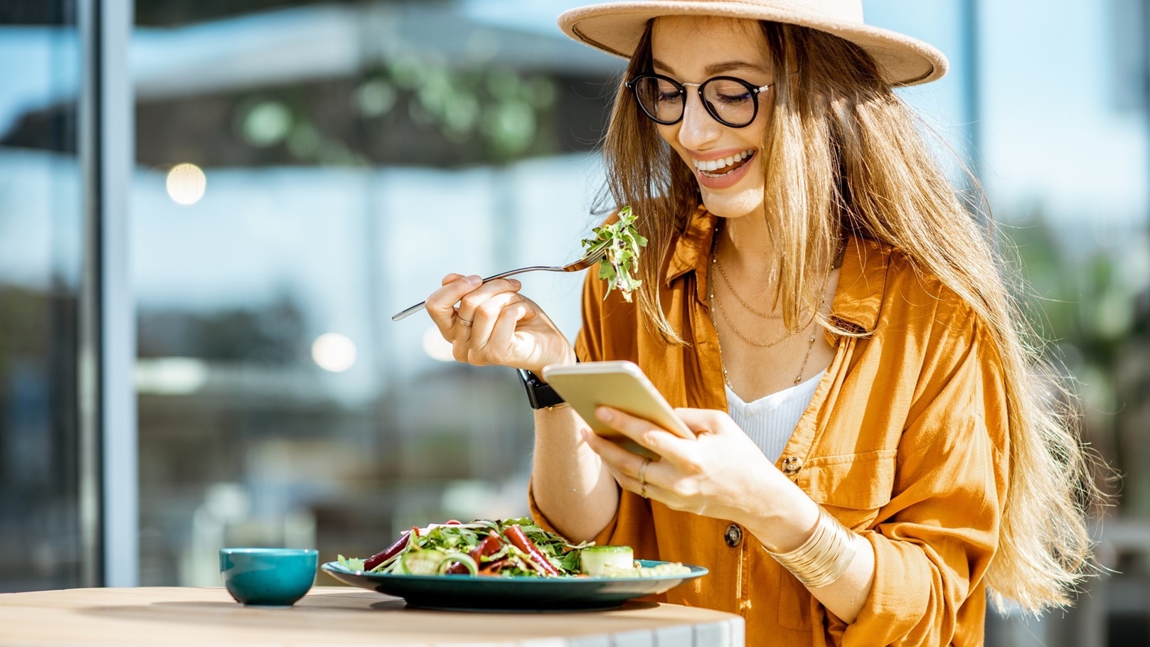 woman-eating-salad-on-a-cafe-terrace-2022-01-18-23-53-19-utc