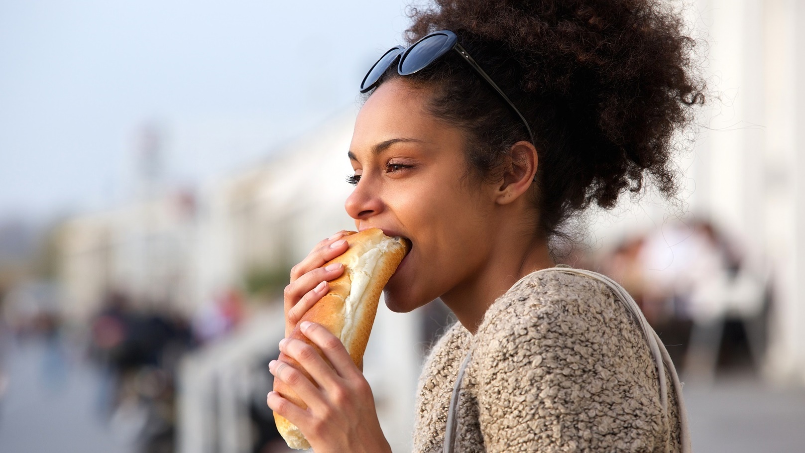 beautiful-young-woman-eating-sandwich-outdoors-2021-08-26-23-05-06-utc