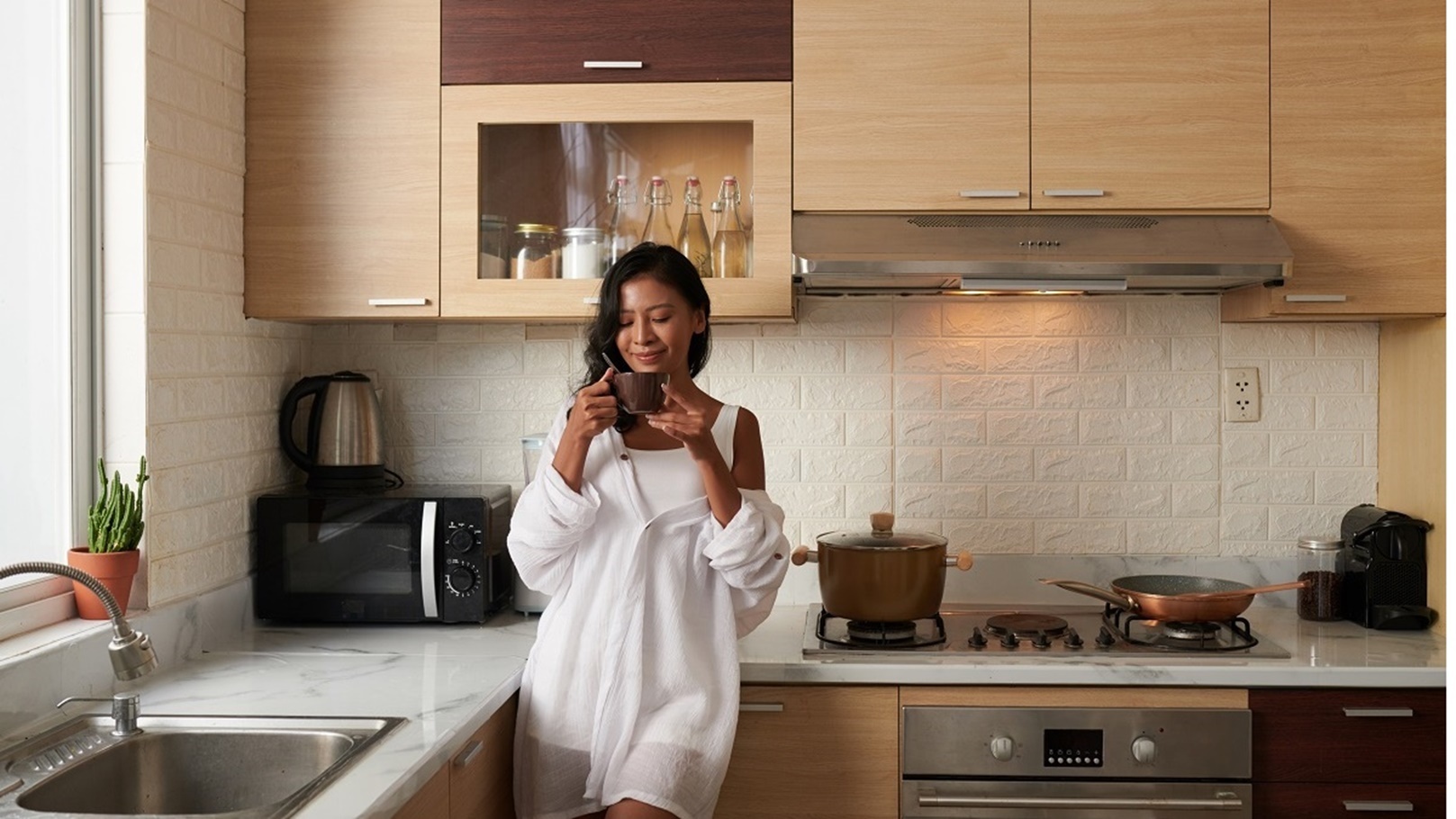 woman-drinking-coffee-in-kitchen-2022-03-09-03-05-55-utc
