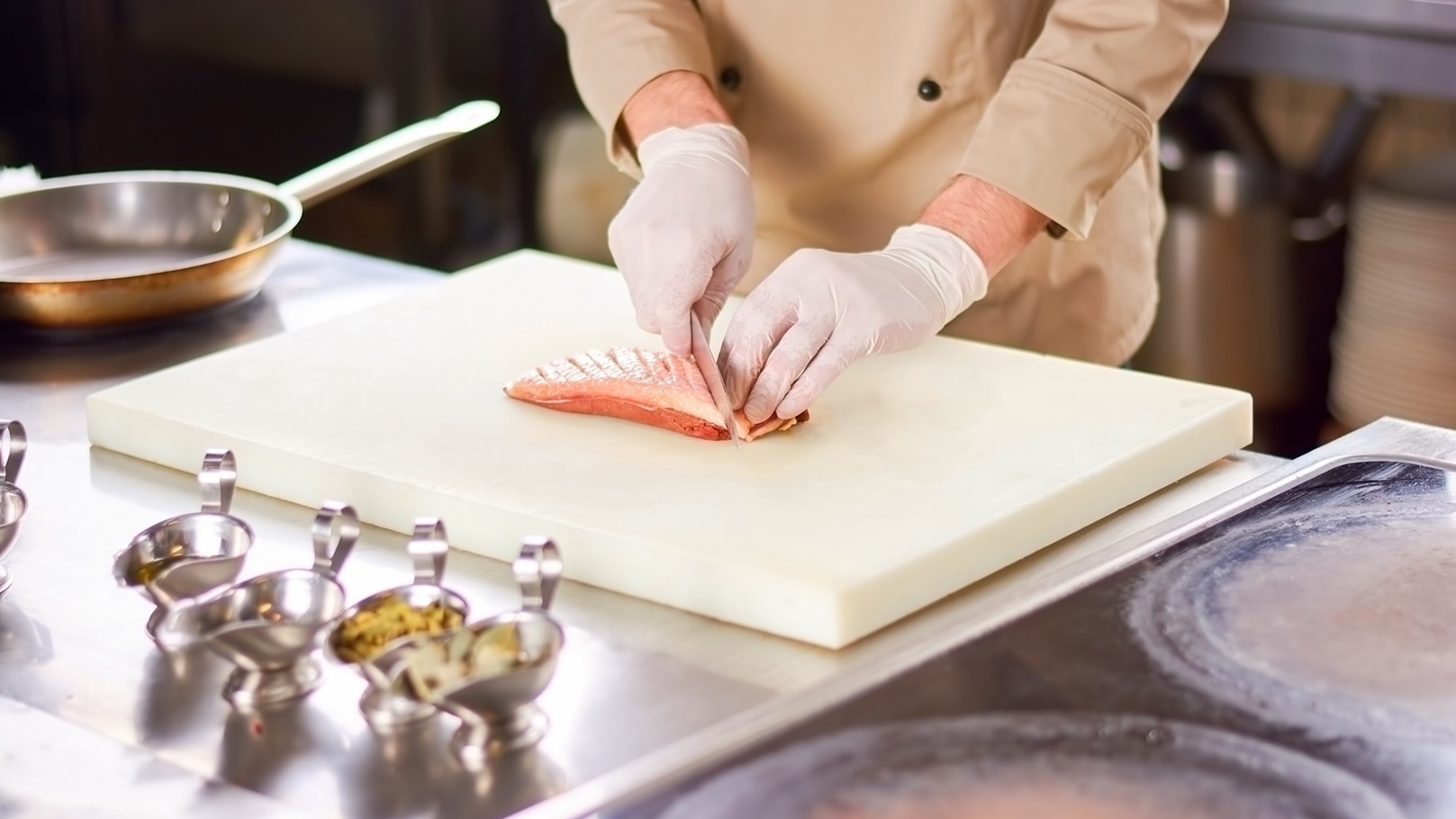 male-chef-dicing-meat-of-poultry-2021-09-02-07-24-28-utc