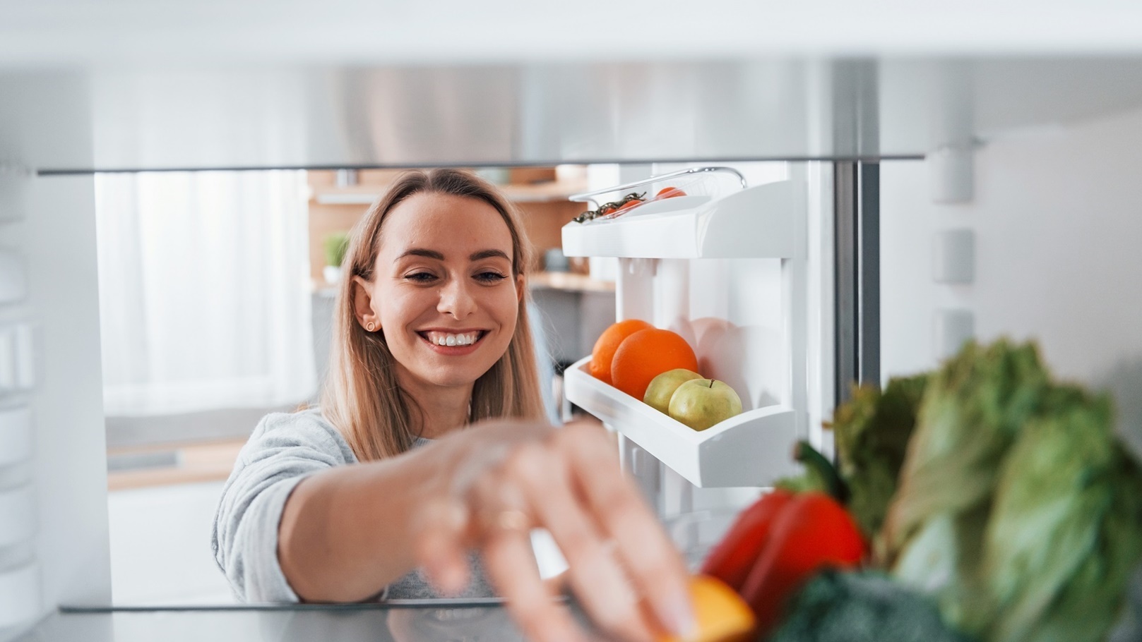 happy-woman-taking-vegetable-from-the-fridge-2022-02-03-21-15-41-utc