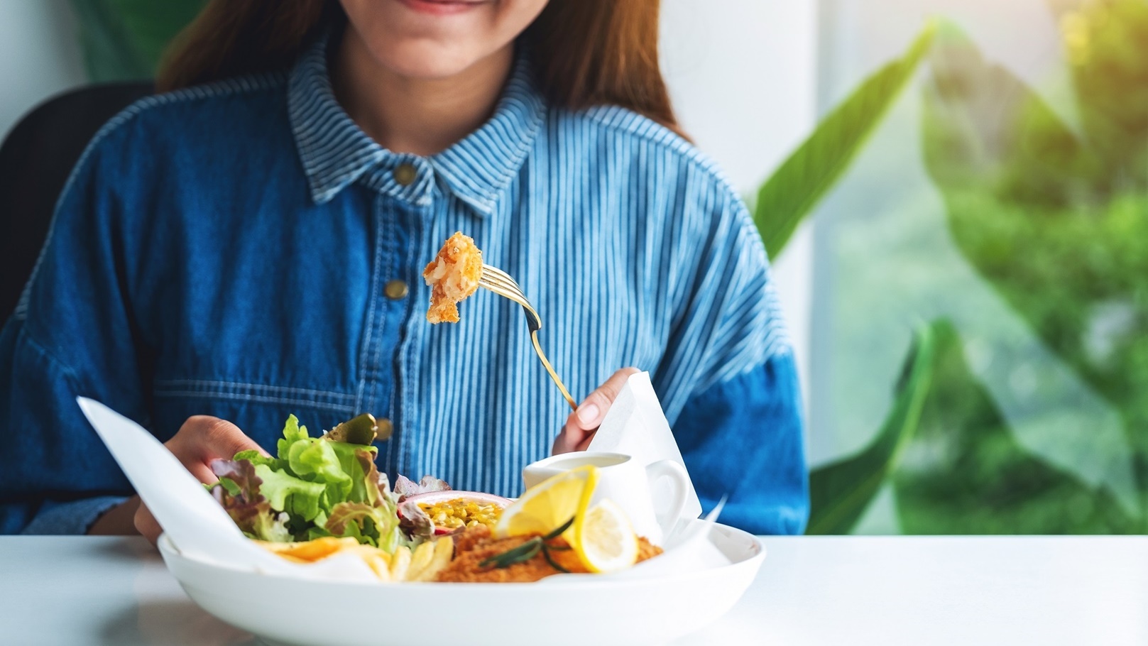 closeup-image-of-a-beautiful-asian-woman-eating-fi-2021-10-21-03-31-07-utc