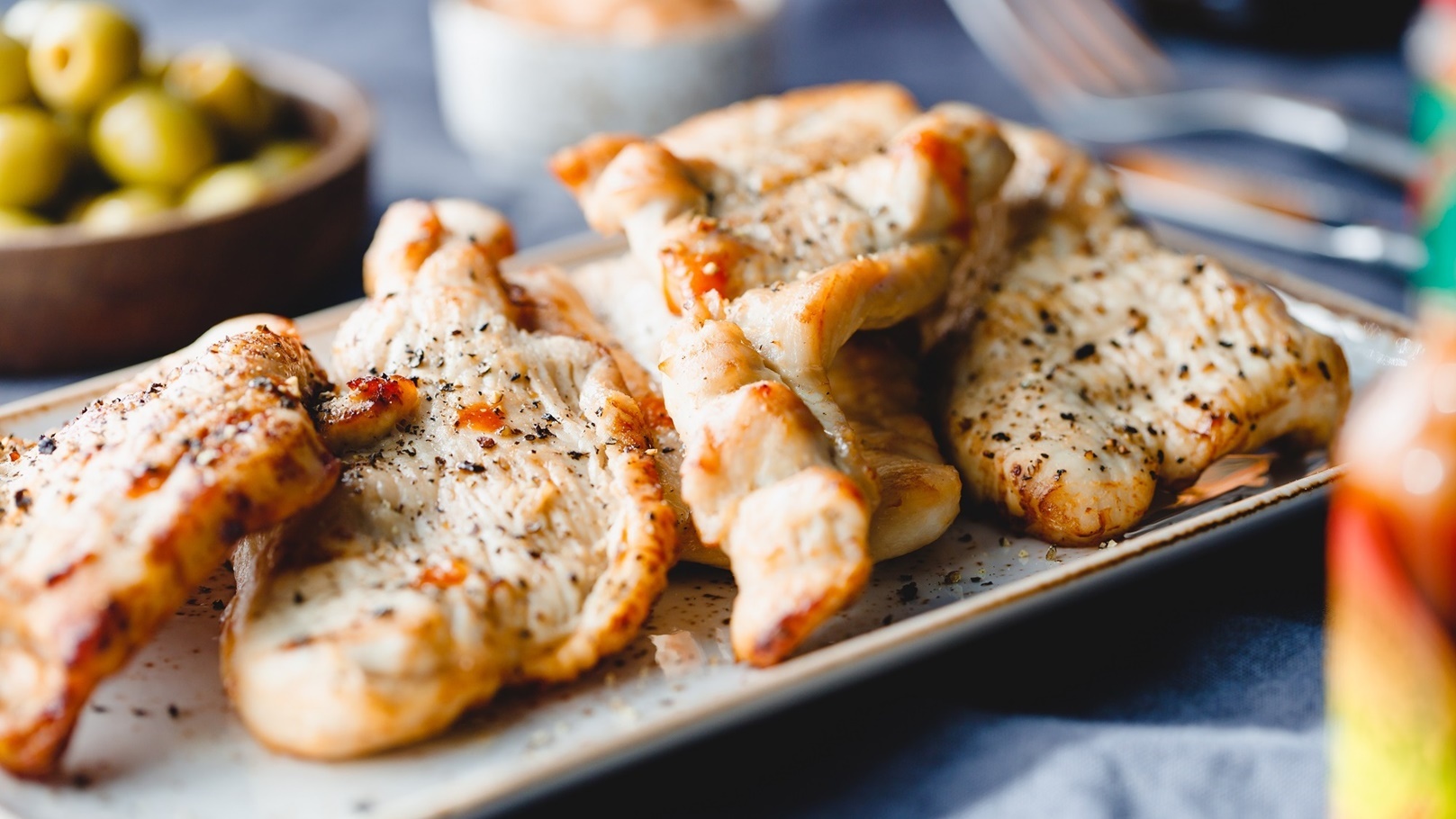 grilled-turkey-escalopes-with-hot-sauce-on-a-table-2021-08-27-22-32-11-utc