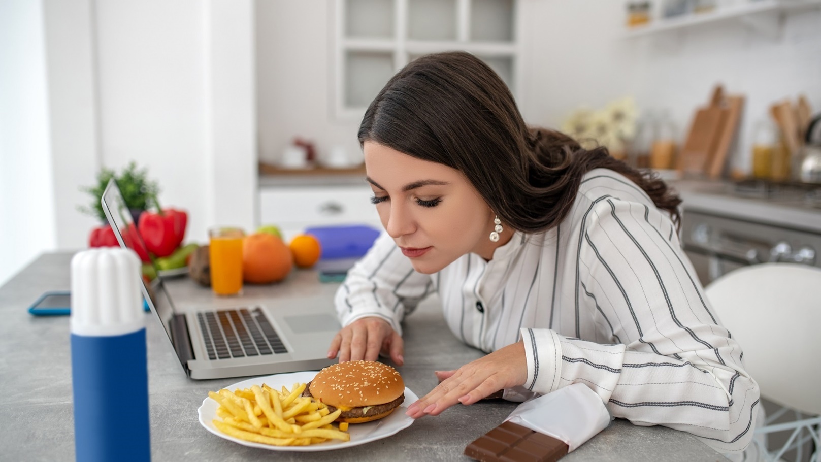 dark-haired-woman-in-a-striped-blouse-eating-burge-2021-09-04-07-17-11-utc