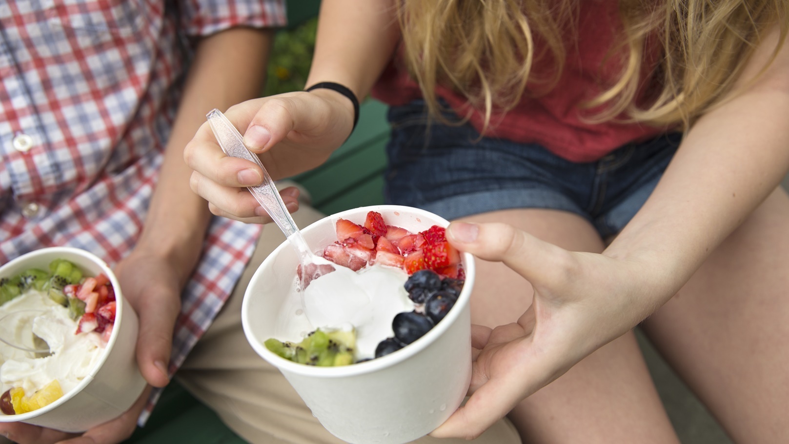 young-people-sitting-side-by-side-eating-fresh-or-2022-03-04-02-32-07-utc