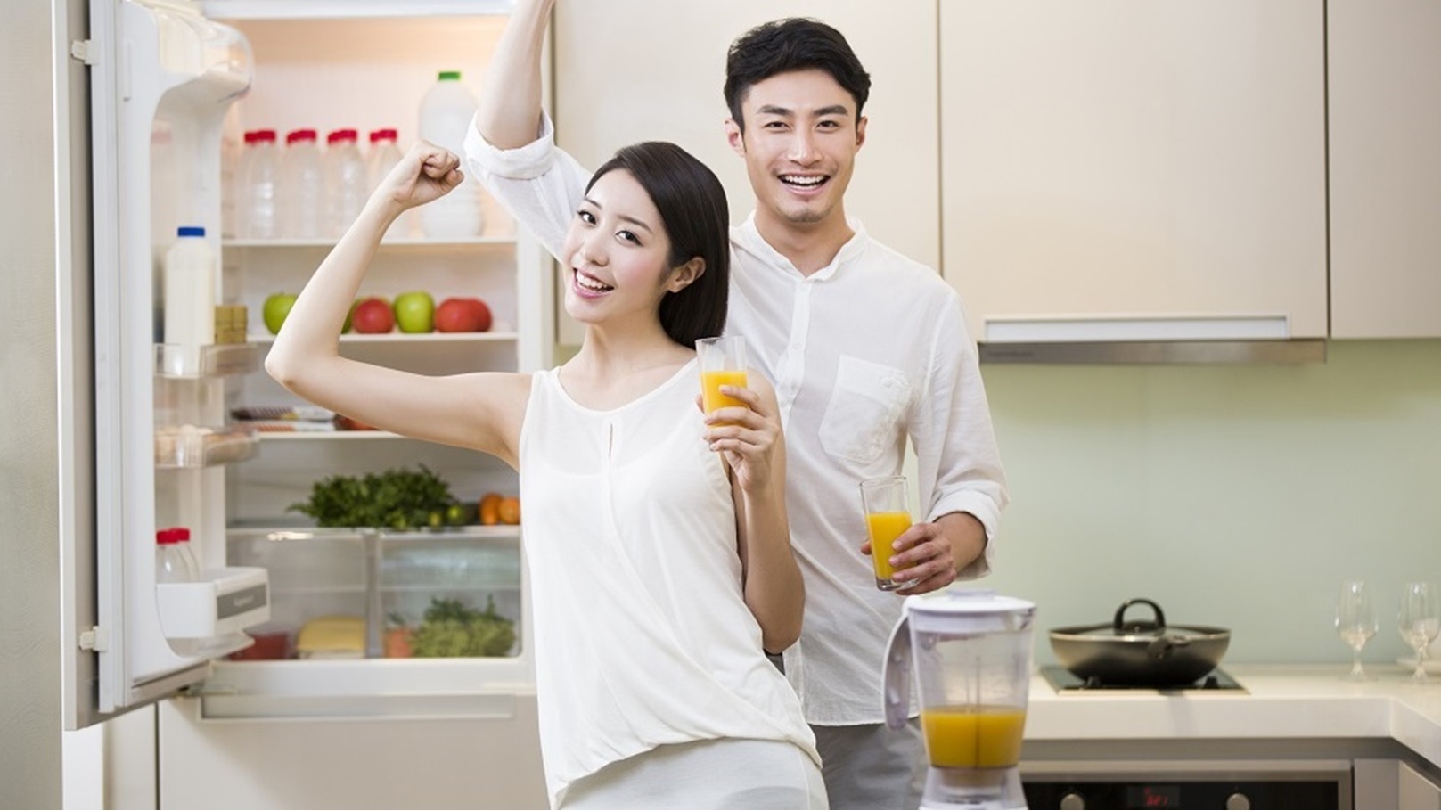 young-couple-cheering-with-orange-juice-2022-04-01-20-22-34-utc