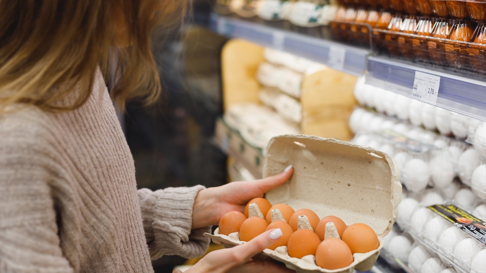 woman-chooses-chicken-eggs-in-a-farm-food-store-f-2022-04-07-20-09-11-utc