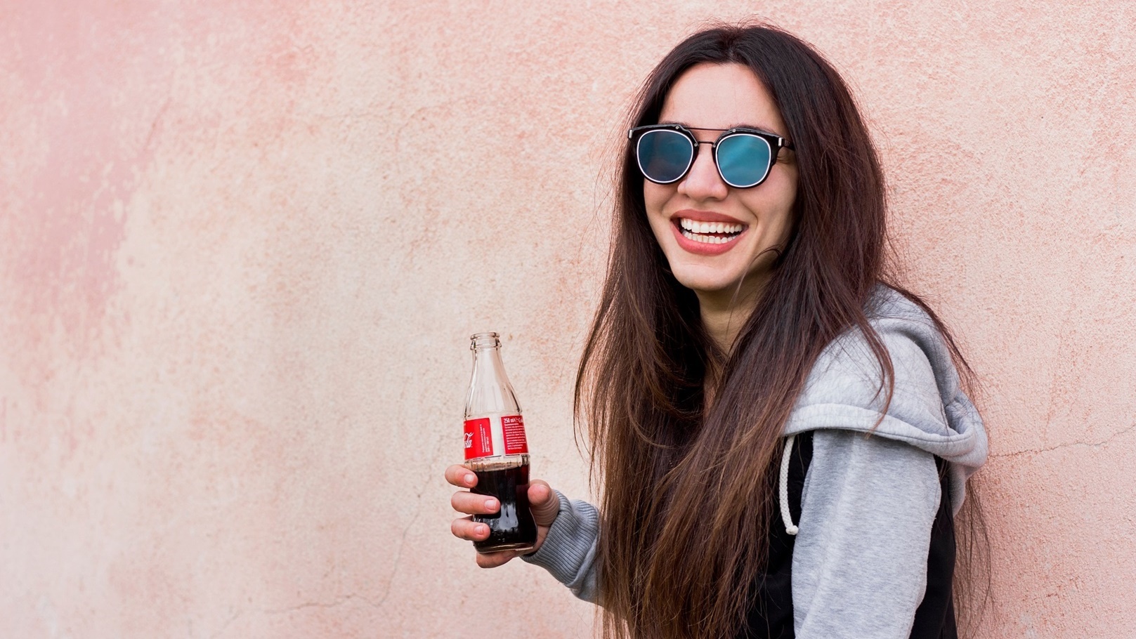 a-woman-with-sunglasses-holds-coca-cola-bottle-and-2021-09-04-03-02-49-utc