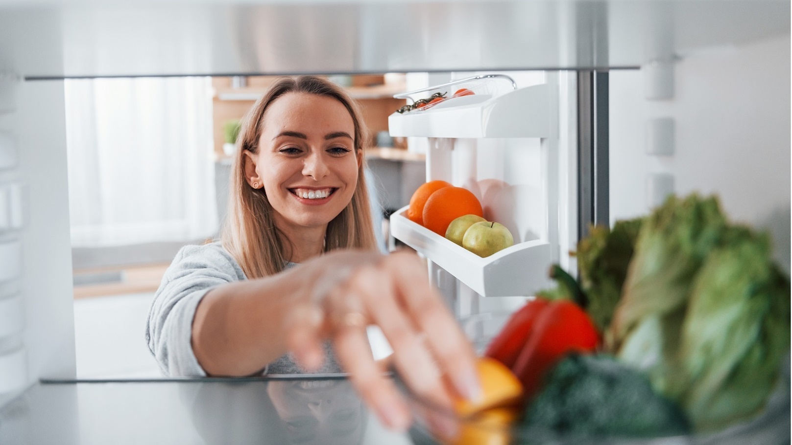 happy-woman-taking-vegetable-from-the-fridge-2022-02-03-21-15-41-utc