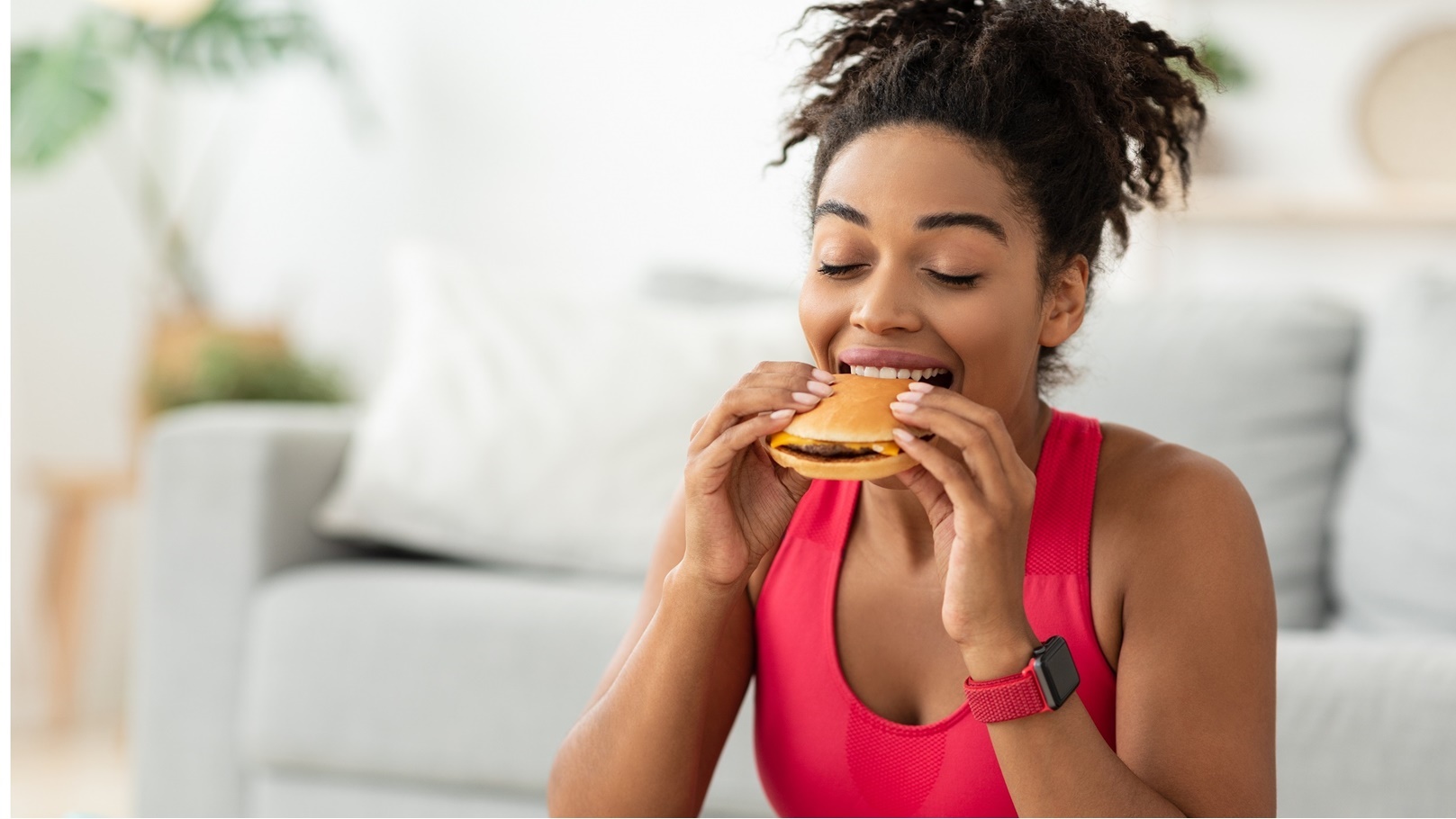 black-fit-woman-eating-burger-after-training-at-ho-2021-08-29-05-18-34-utc