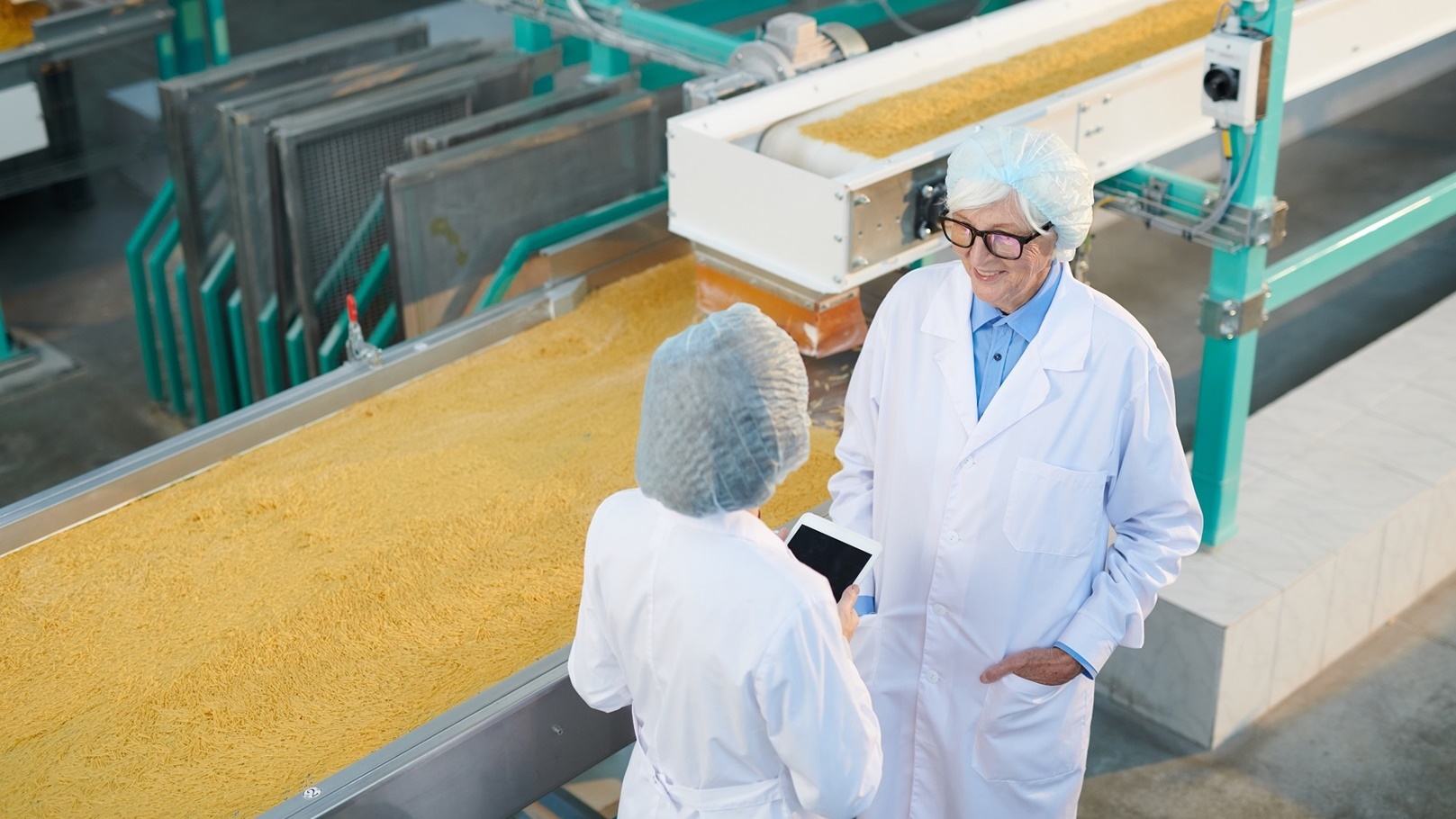 two-factory-workers-at-production-line-2022-02-02-04-49-12-utc (1)