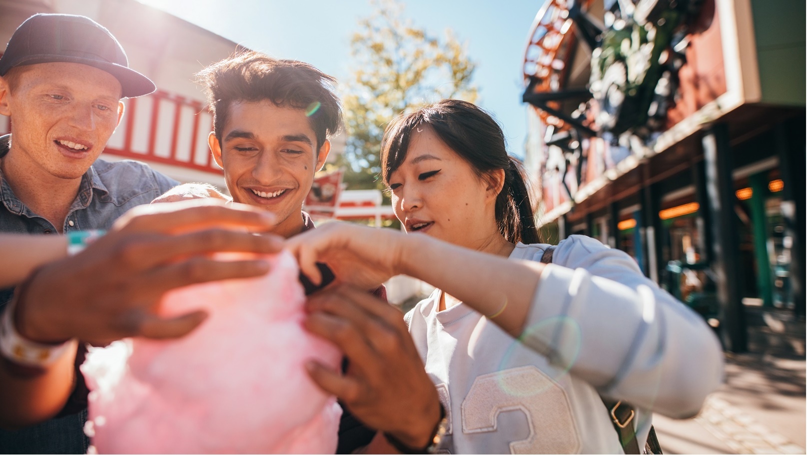 group-of-friends-eating-cotton-candy-in-amusement-2022-02-02-05-05-21-utc