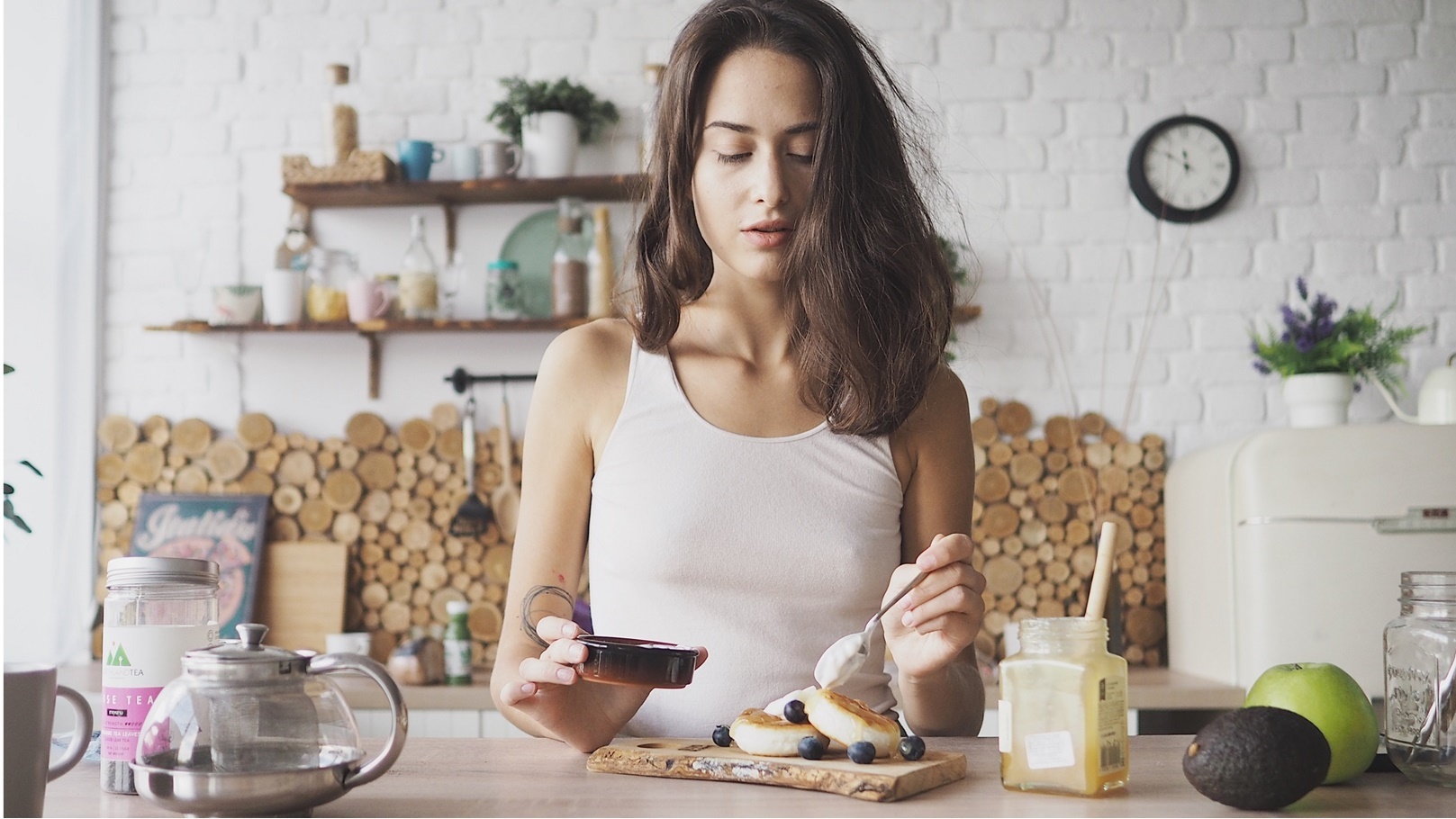young-woman-puts-honey-on-cheese-cakes-homemade-2022-03-04-04-19-20-utc