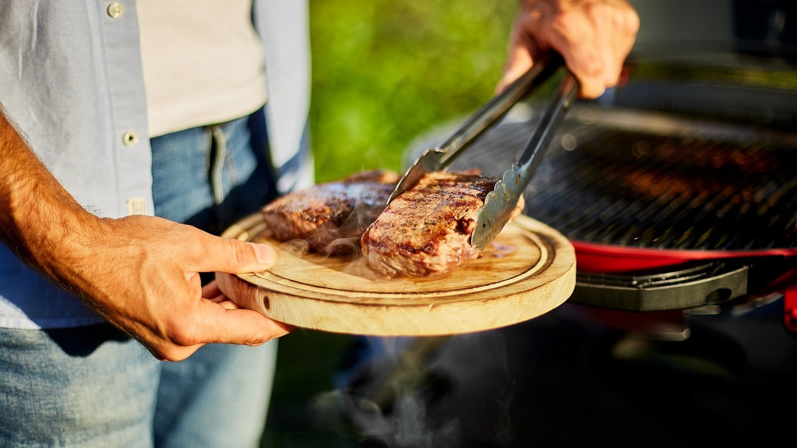 man-put-down-meat-on-a-wooden-board-ready-to-eat-g-2022-03-30-14-38-14-utc