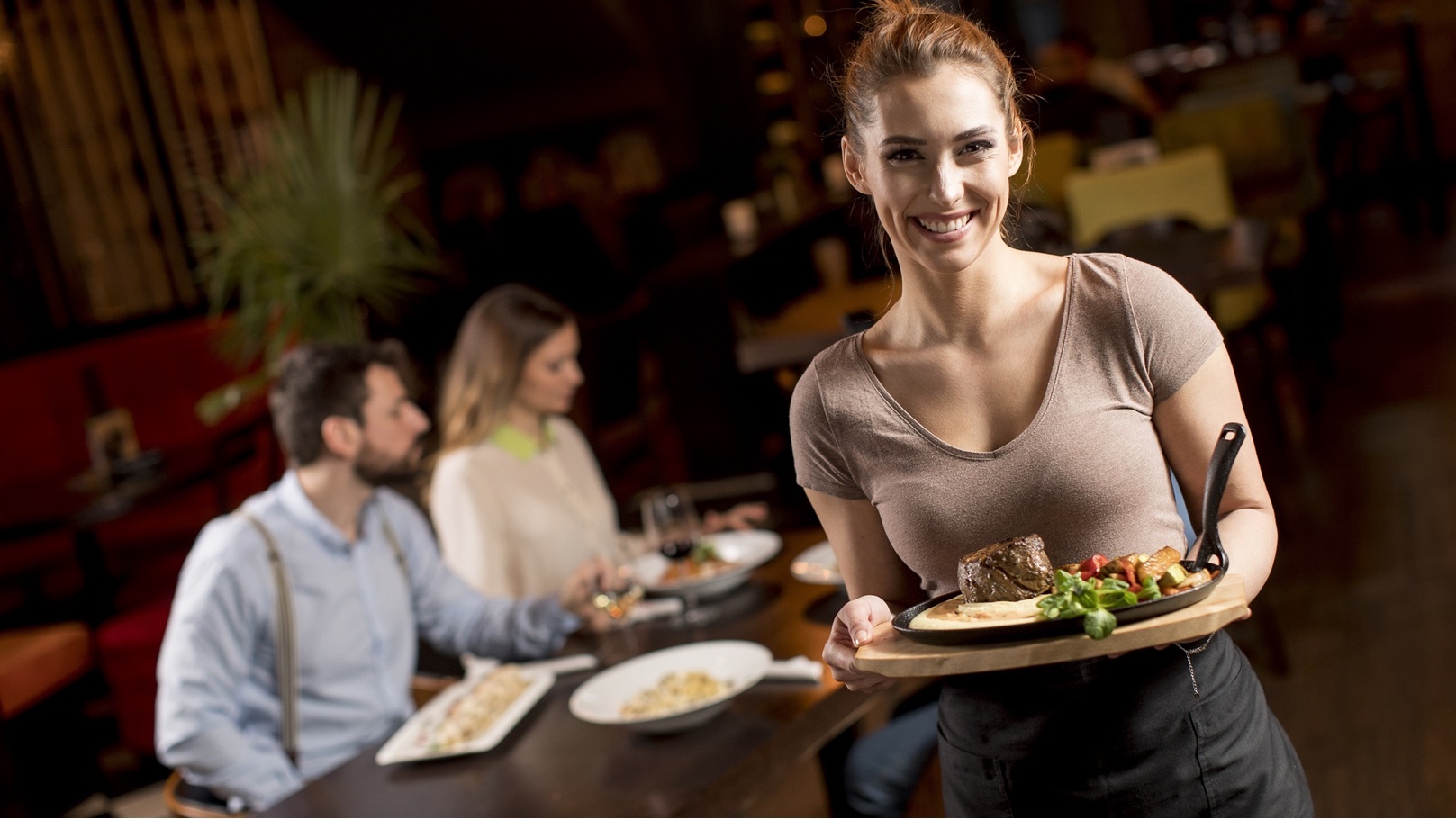 waitress-holding-a-wooden-plate-with-beef-steak-in-2022-04-15-18-41-49-utc