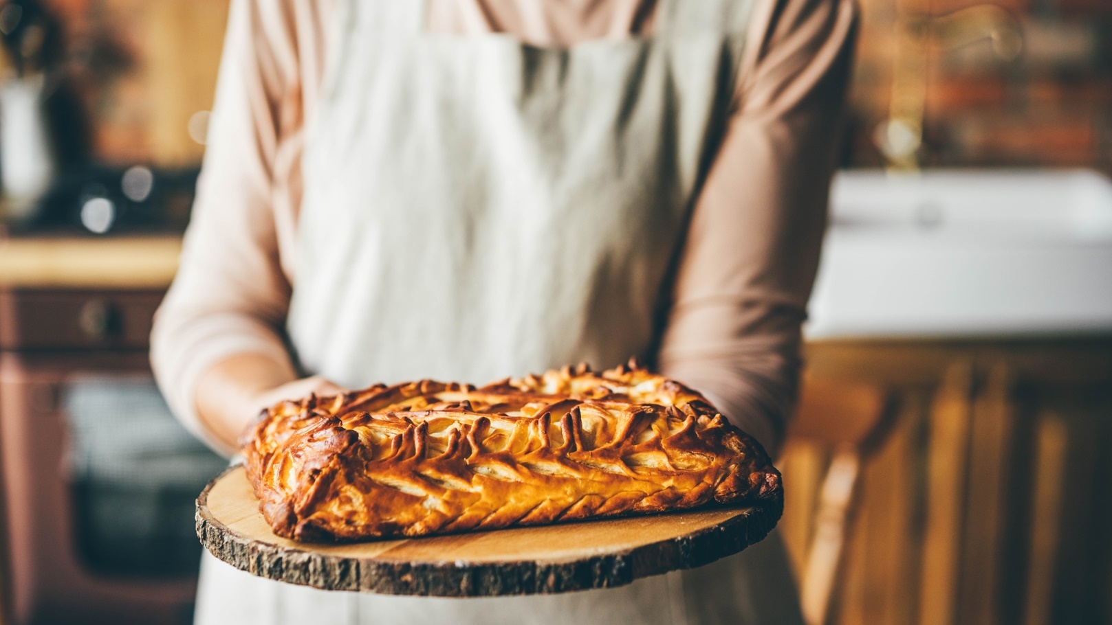 senior-woman-holding-sweet-pie-2021-08-30-13-45-00-utc