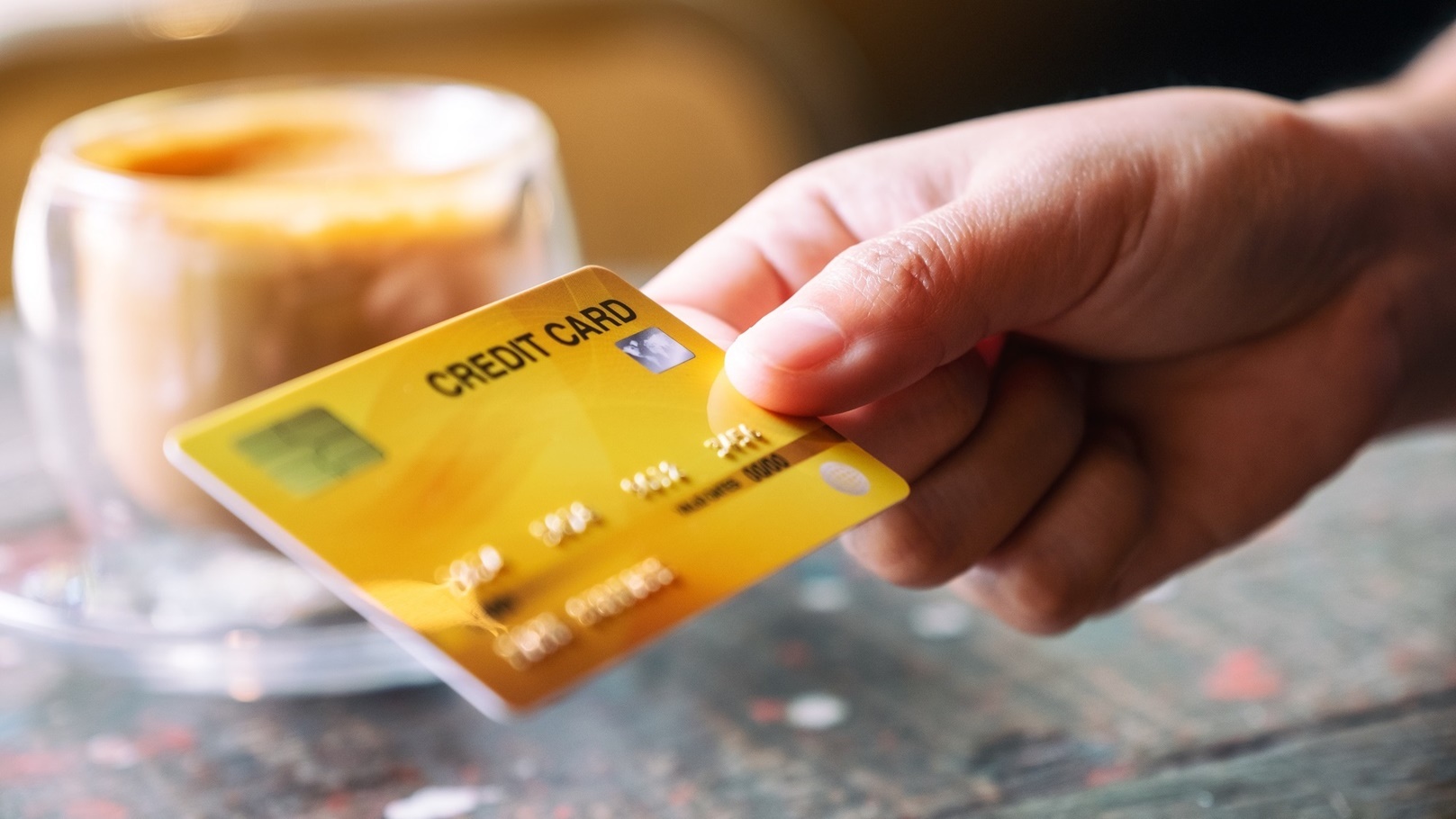 closeup-image-of-a-hand-holding-and-giving-credit-2022-01-28-06-29-49-utc