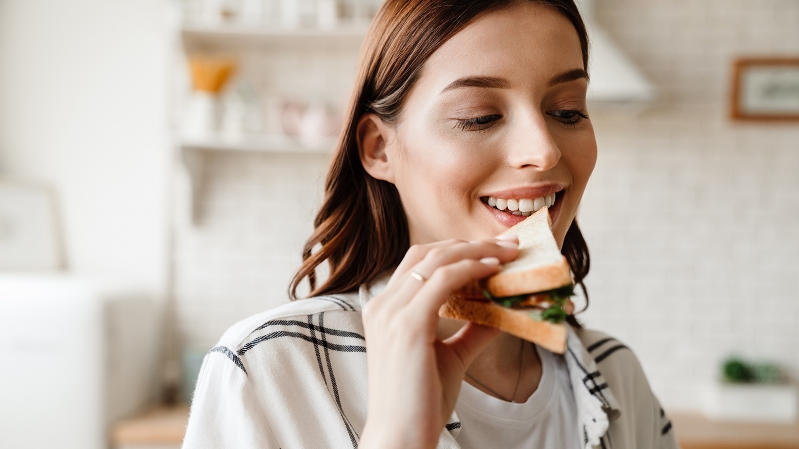 beautiful-happy-woman-smiling-while-eating-sandwic-2022-02-01-22-37-48-utc