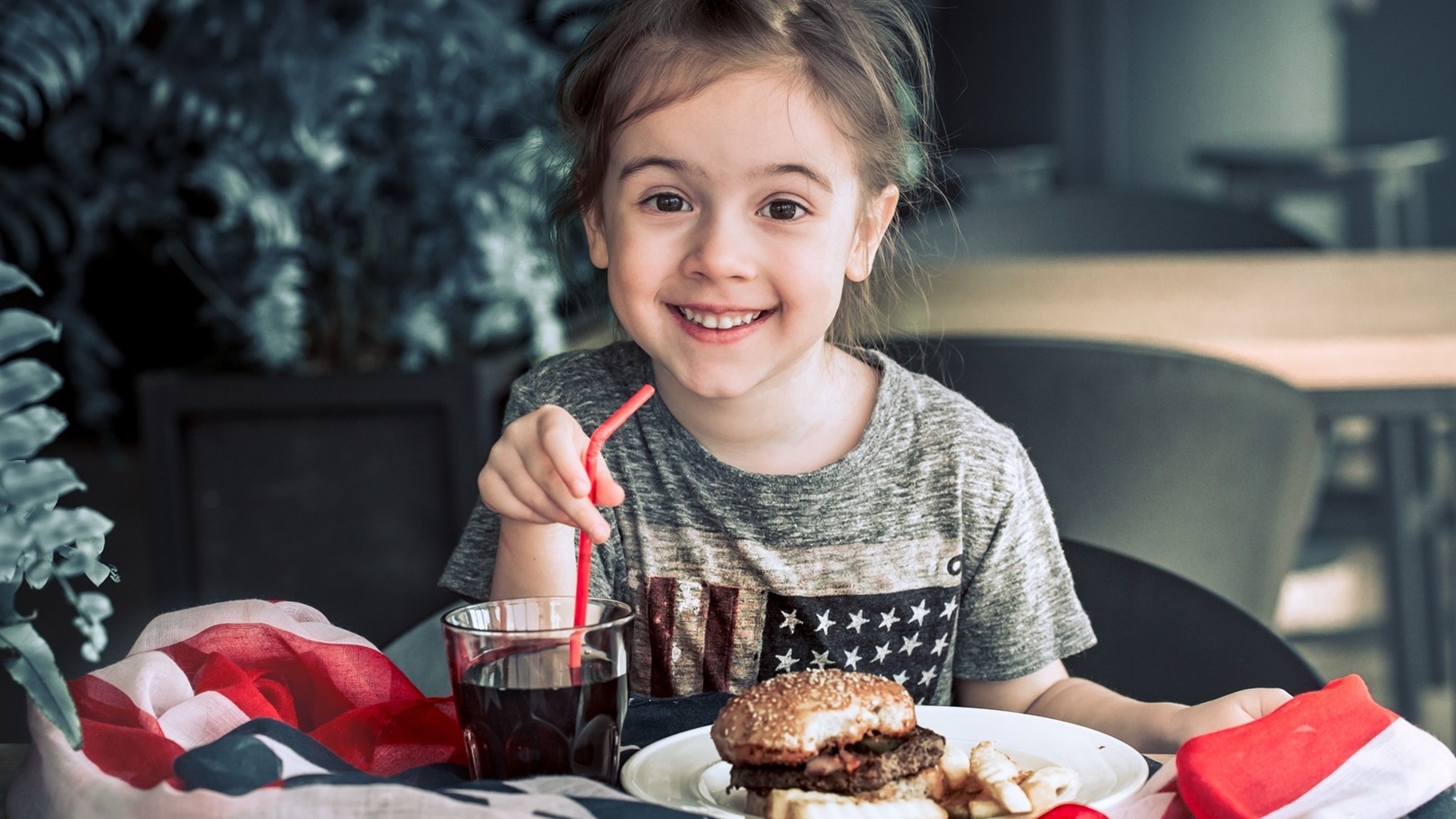 little-girl-in-cafe-with-burger-2021-08-31-10-33-01-utc