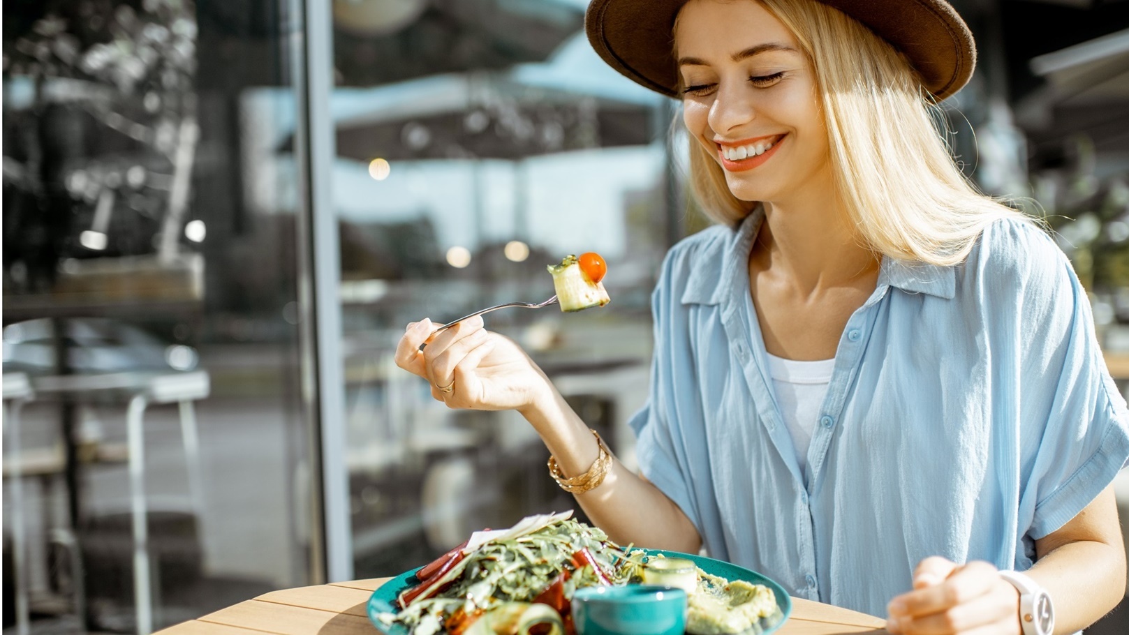 woman-eating-salad-on-a-cafe-terrace-2022-01-18-23-53-59-utc