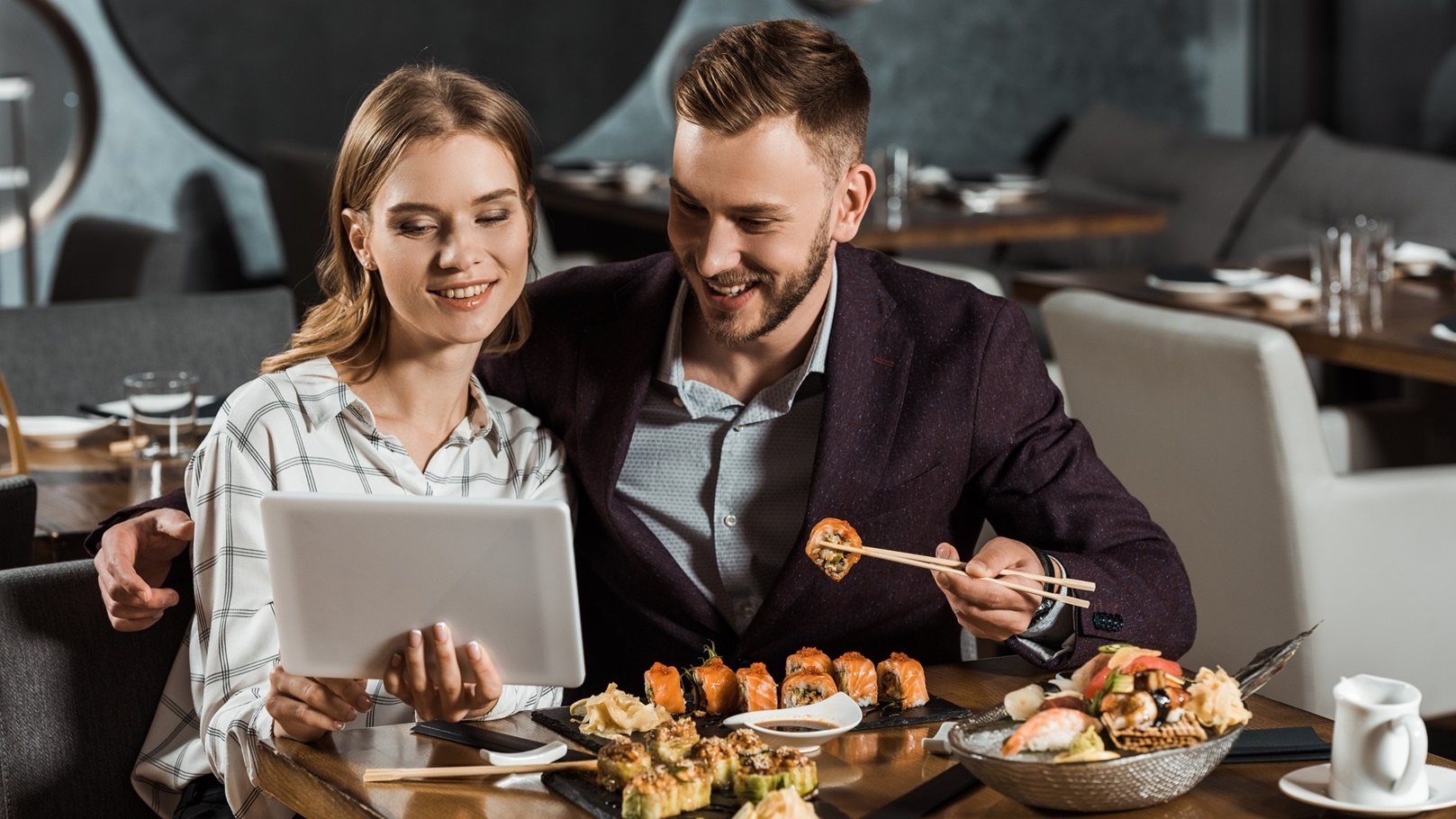 attractive-couple-of-yound-adult-using-digital-tab-2022-01-19-00-05-32-utc