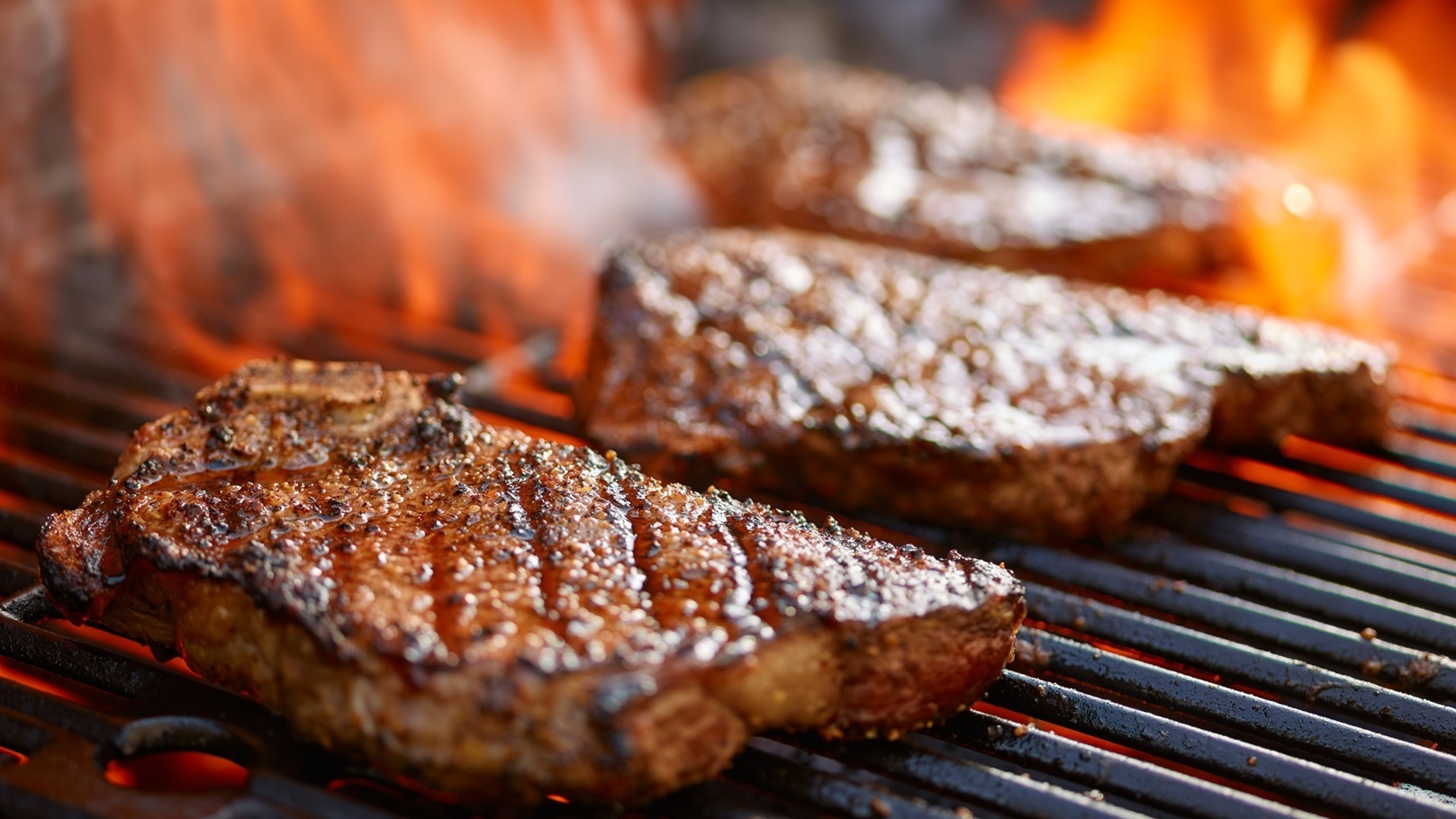 grilling-steaks-on-flaming-grill-and-shot-with-sel-2022-03-26-11-58-49-utc