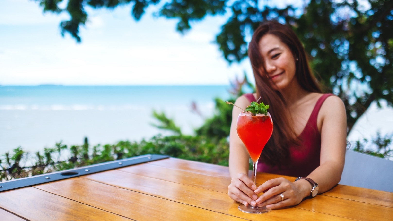 a-beautiful-young-asian-woman-drinking-cocktail-i-2021-10-21-03-26-32-utc
