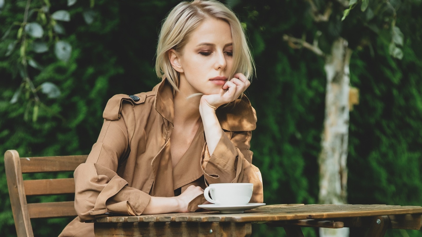 beautiful-woman-in-coat-with-cup-of-coffee-at-wood-2022-01-07-19-33-30-utc