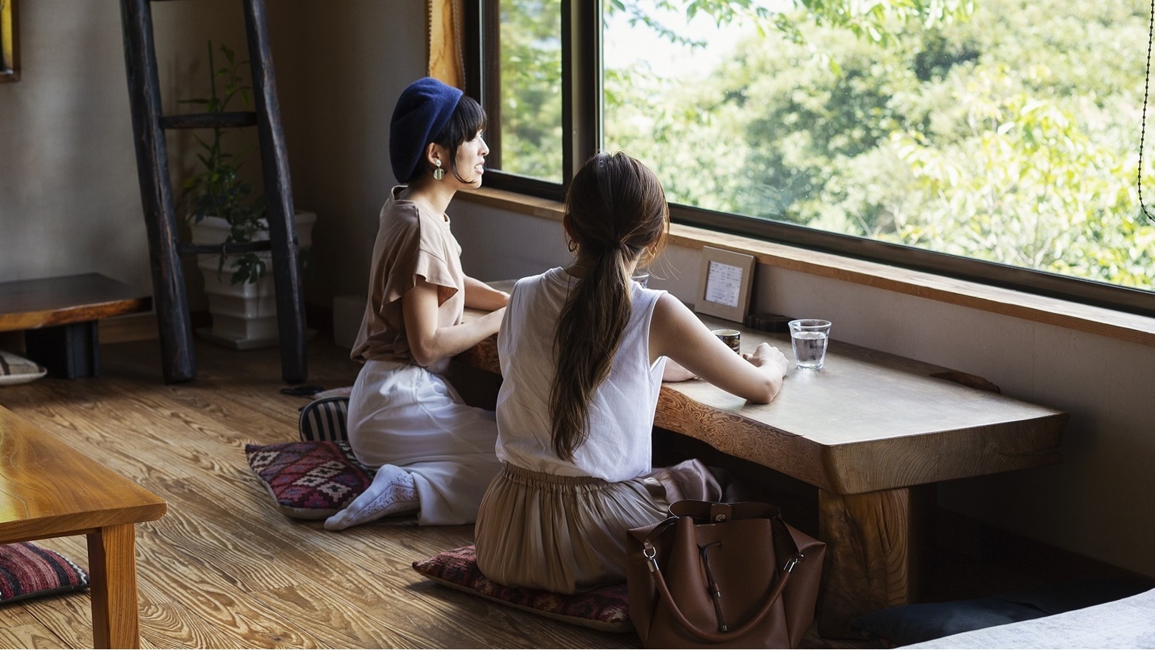 two-japanese-women-sitting-at-a-table-in-a-japanes-2022-03-04-02-33-37-utc