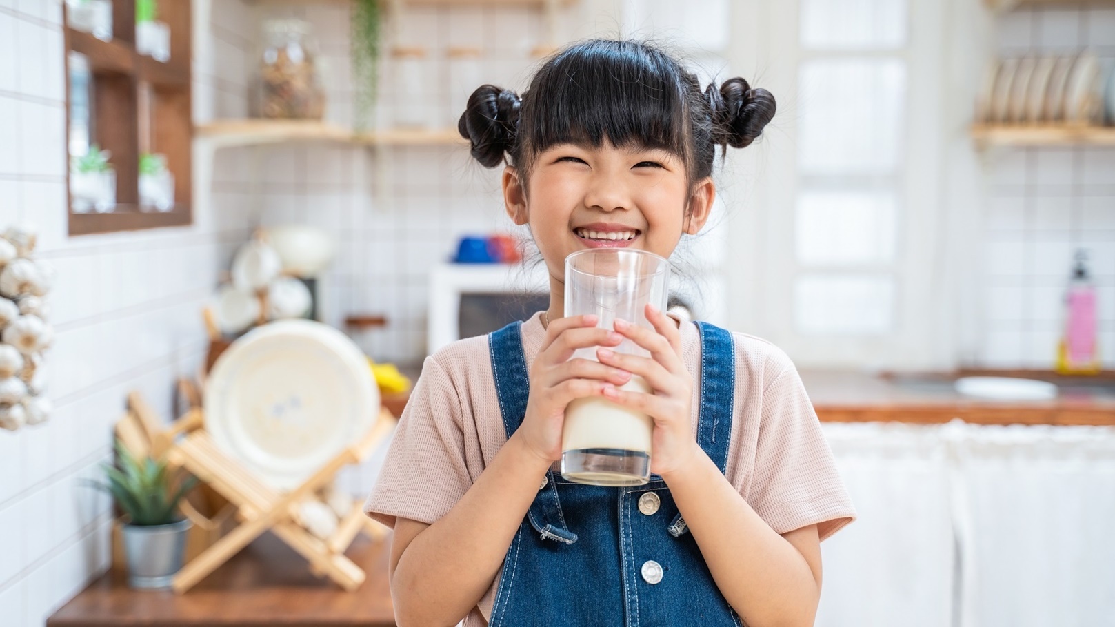 portrait-of-asian-little-cute-kid-holding-a-cup-of-2021-12-09-02-32-20-utc