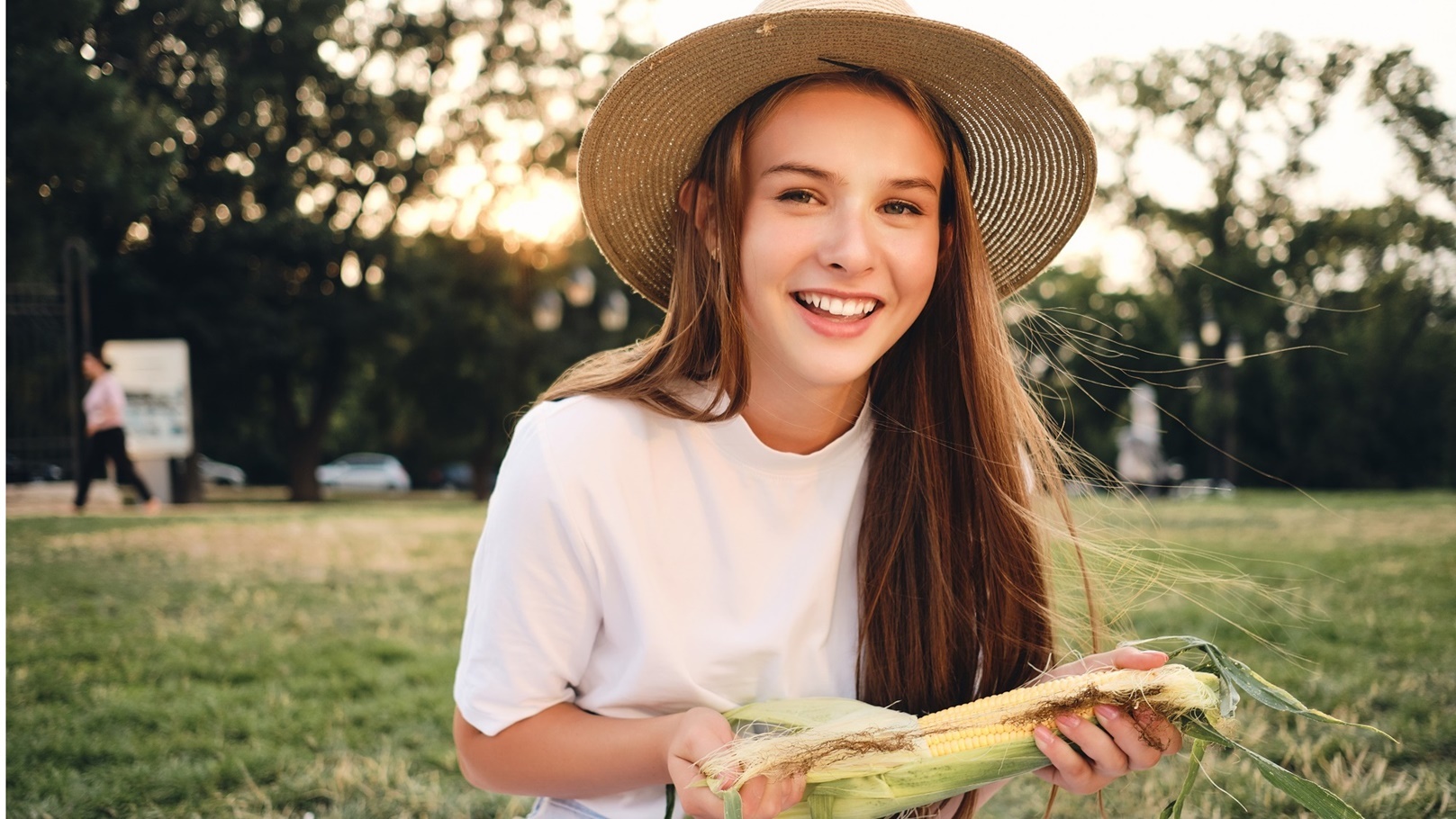 cheerful-teenage-girl-in-straw-hat-holding-corn-in-2022-02-02-04-48-37-utc