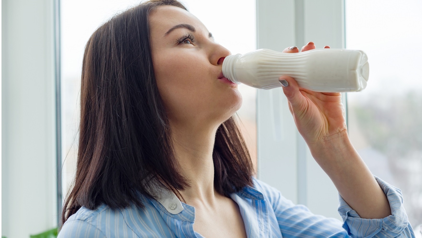 young-beautiful-woman-with-bottle-of-milk-yogurt-2022-03-16-22-13-45-utc